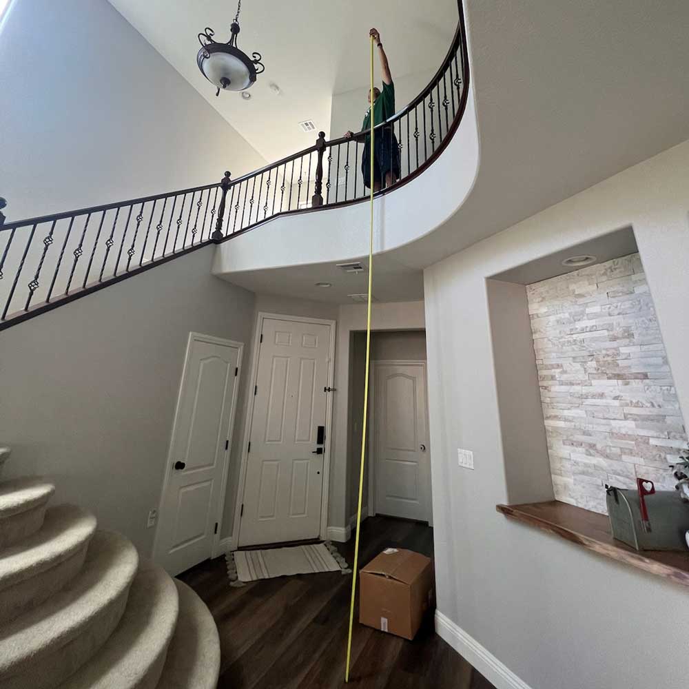 Cordan Electric technician working in a two story Las Vegas foyer